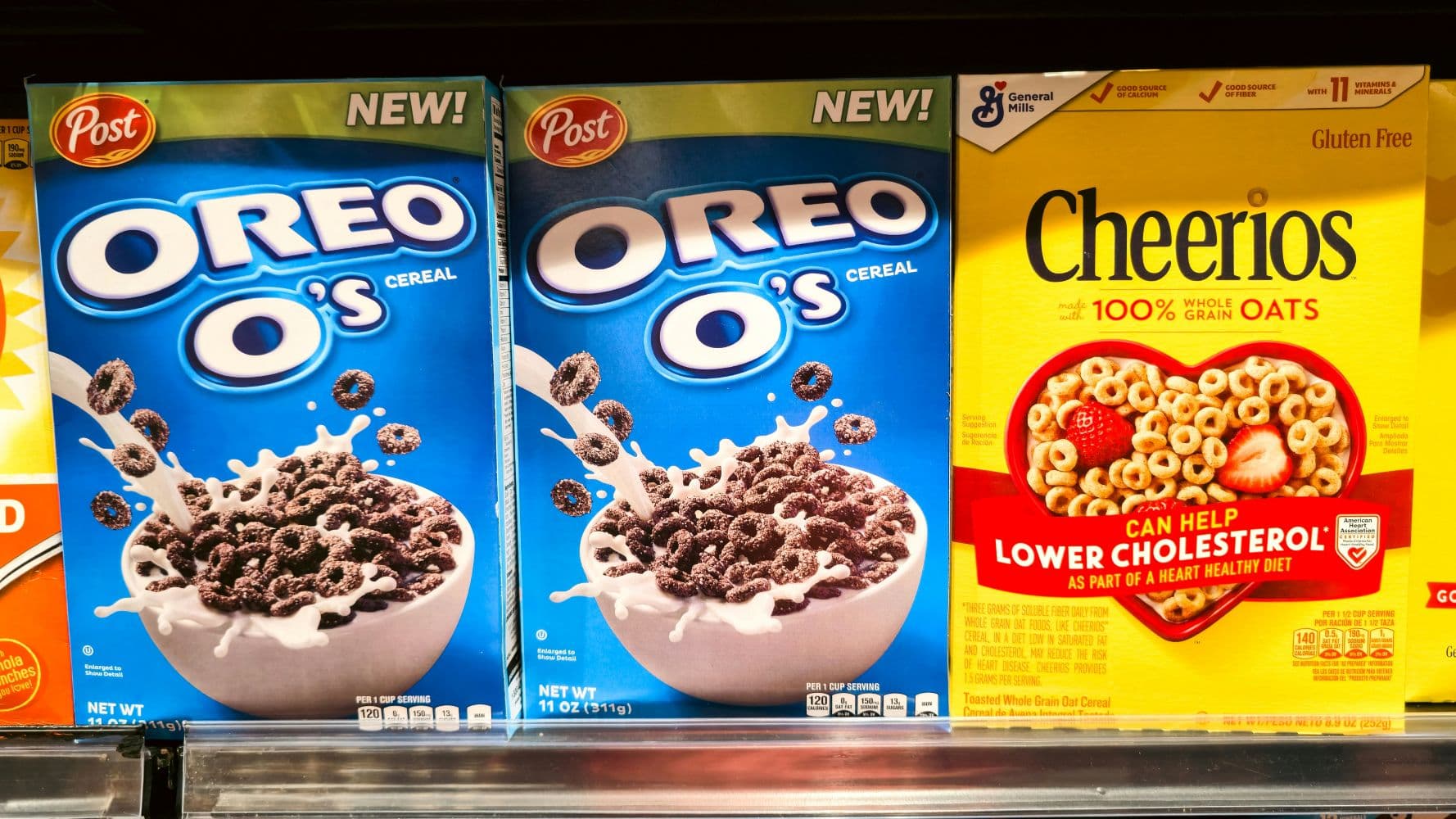 Boxes of Oreo O's and Cheerios cereal displayed on a store shelf.