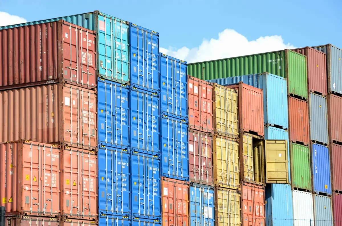 Colorful intermodal shipping containers stacked at a port.